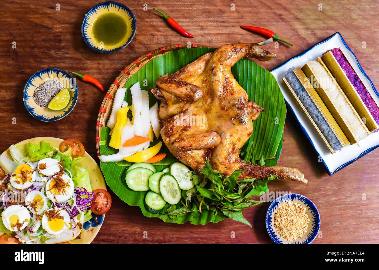 Grilled chicken in vietnamese style with colorful rice in bamboo, and
