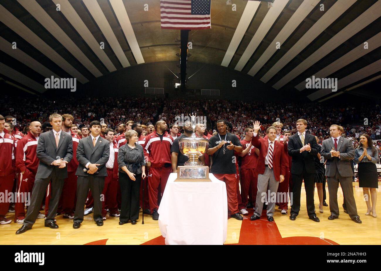 alabama-football-coach-nick-saban-and-players-stand-behind-the-iron