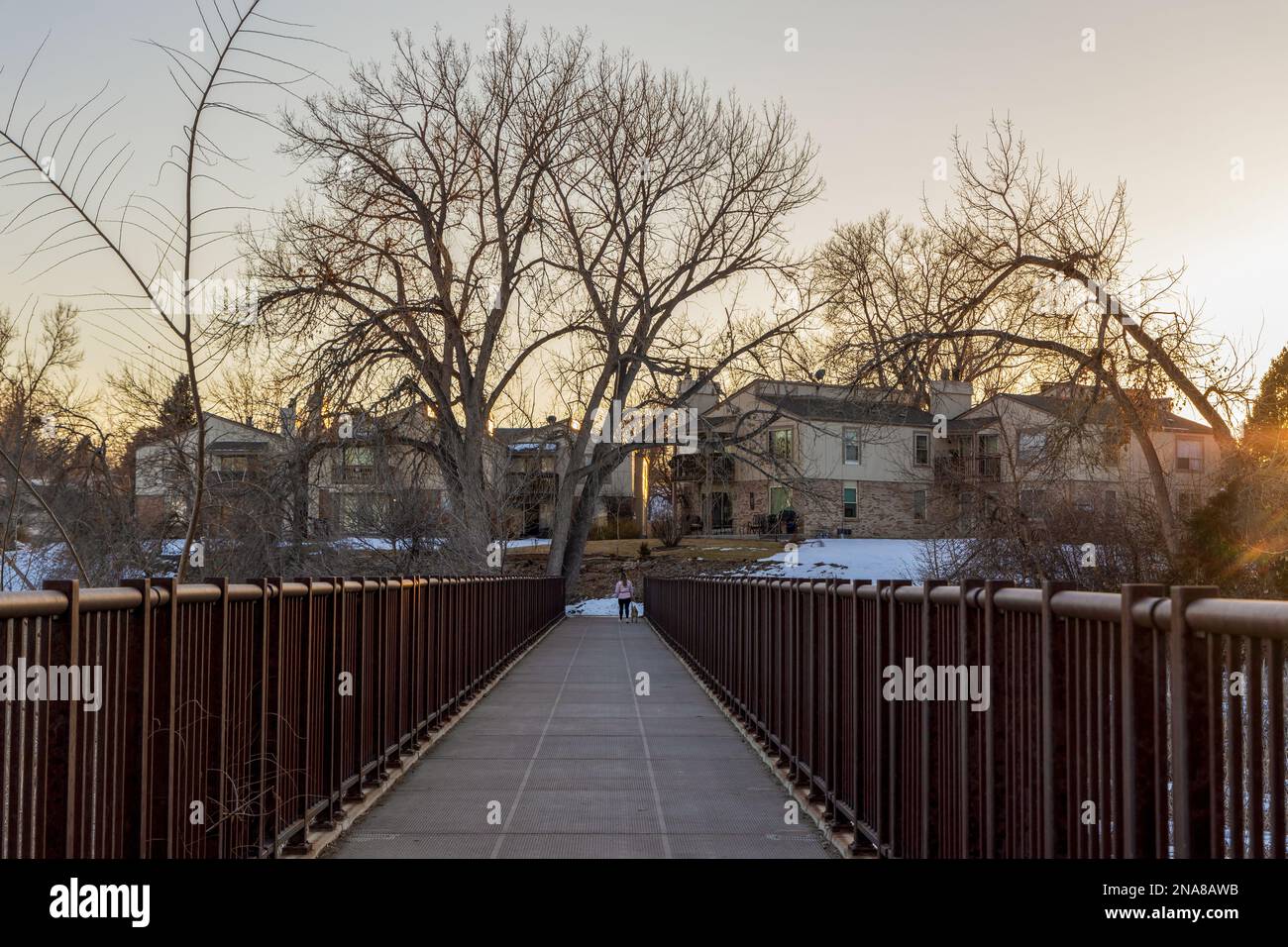 Kendrick Lake Park in Denver, Colorado. Iced lake at sunset with houses