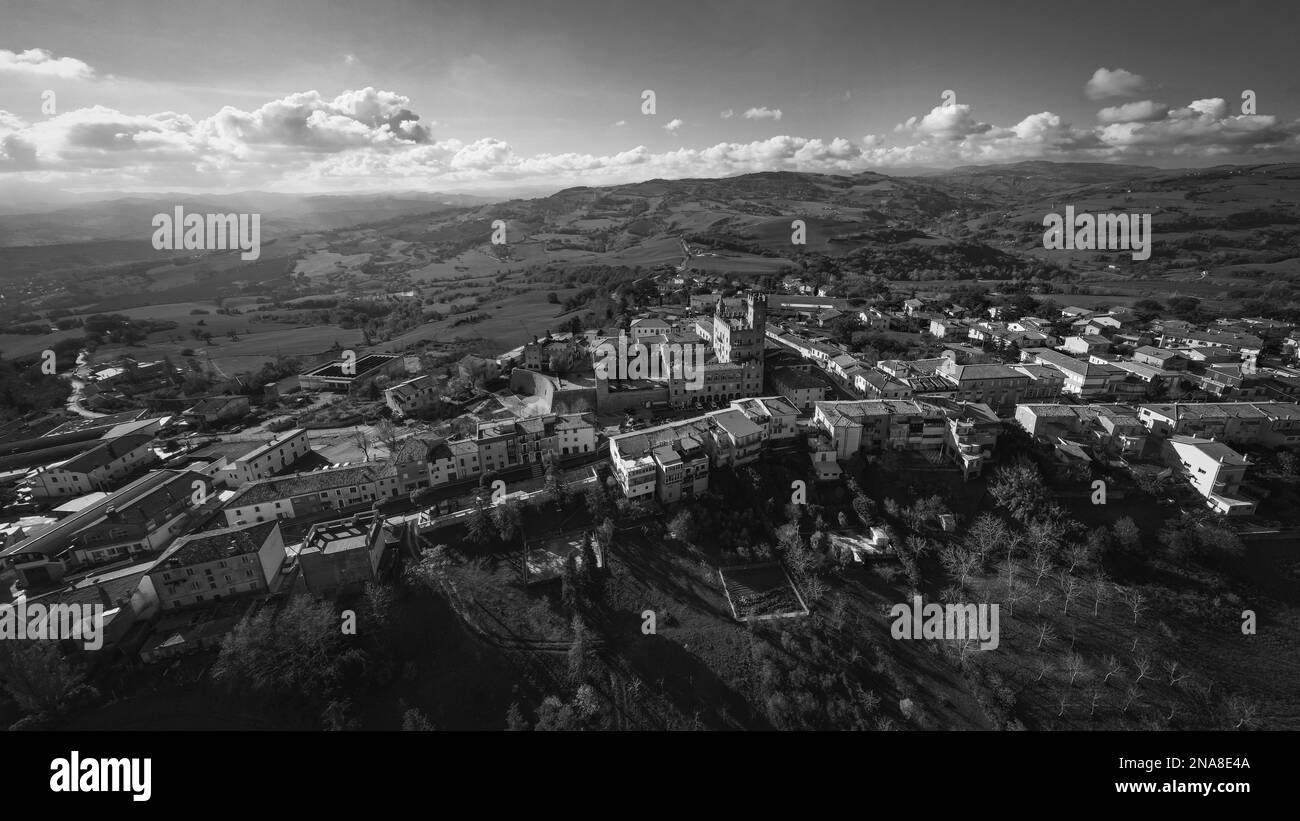An aerial grayscale of the beautiful buildings of the medieval Tavoleto village in Italy on a sunny day Stock Photo