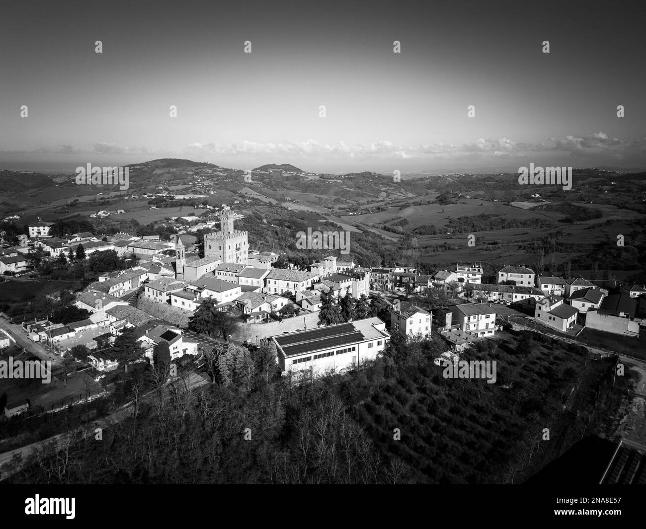 An aerial grayscale of the beautiful buildings of the medieval Tavoleto village in Italy on a sunny day Stock Photo