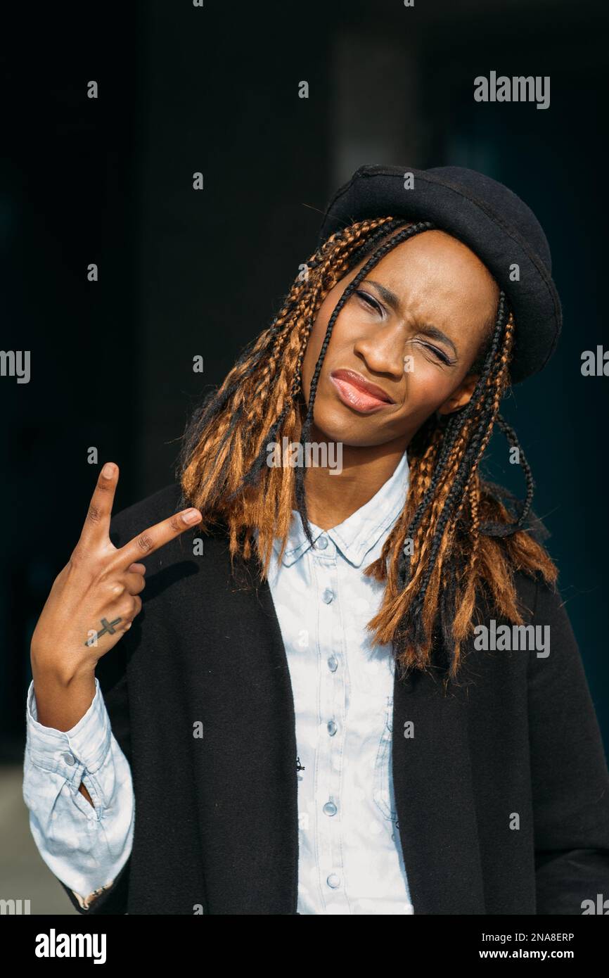 Victory gesture. Confident young black lady Stock Photo