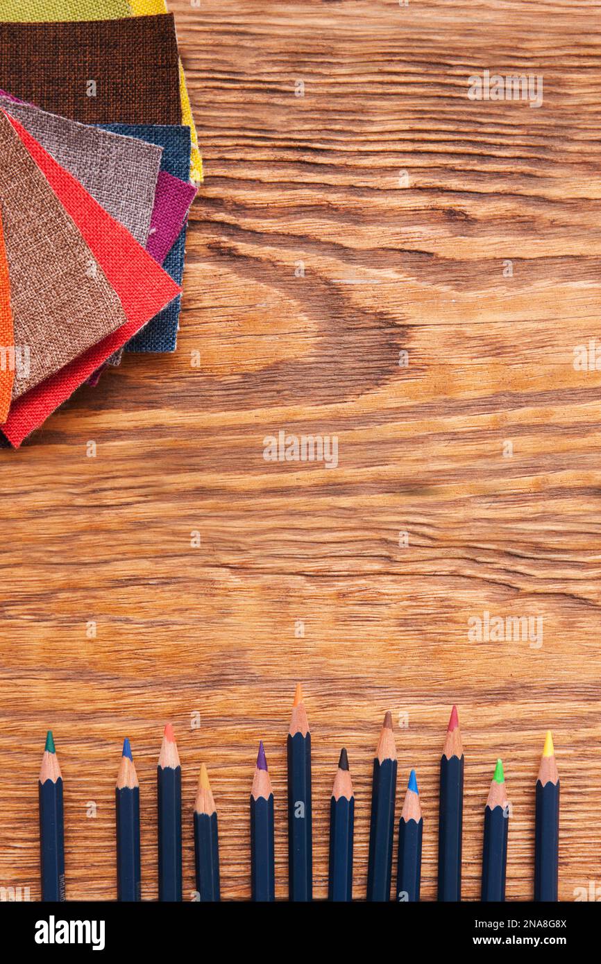 Workplace of fashion designer. Pencils and fabrics Stock Photo - Alamy