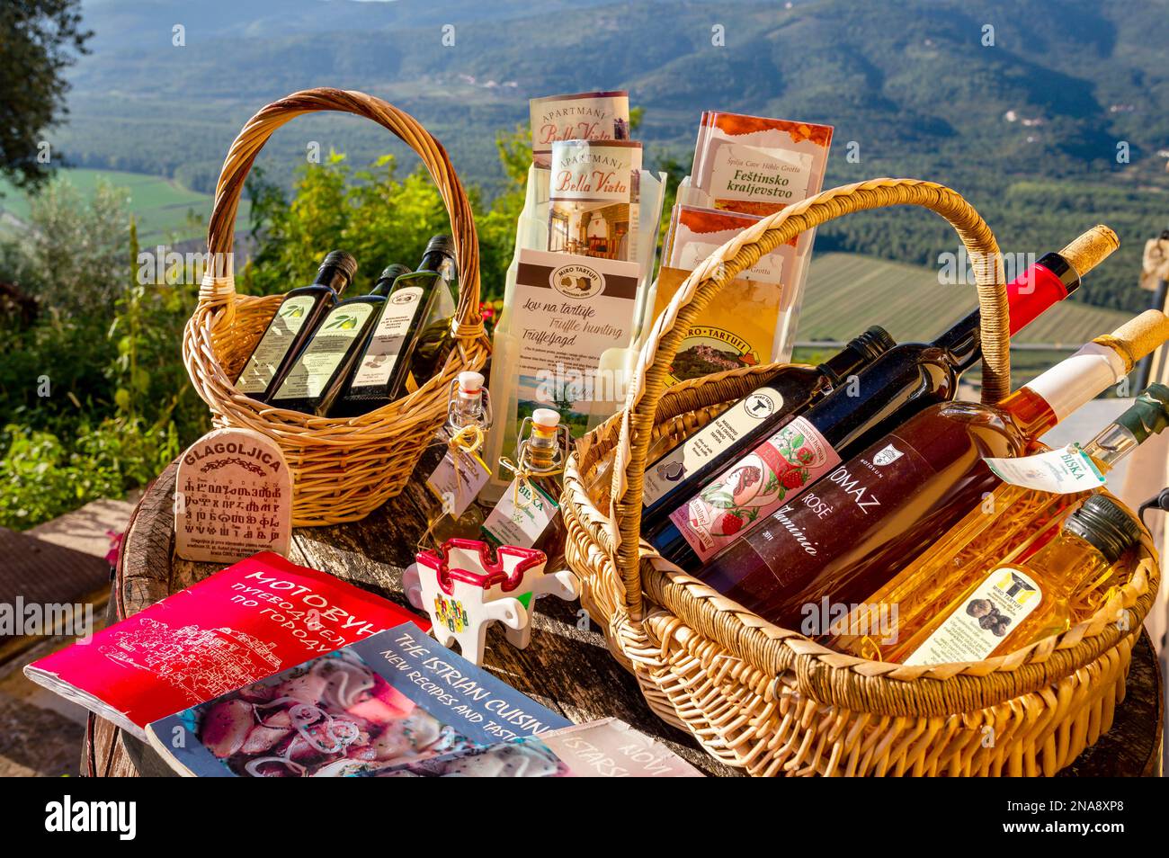 Baskets of olive oil and wine bottles and brochures advertising the traditional food industries; Motovun, Croatia Stock Photo
