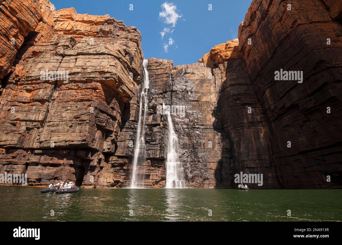 Expedition travelers aboard a zodiac inflatable boat explores the King George River and waterfall in the Kimberley Region of Western Australia. Stock Photo