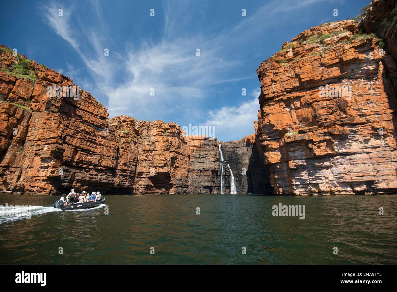 Expedition travelers aboard a zodiac inflatable boat explores the King George River and waterfall in the Kimberley Region of Western Australia. Stock Photo