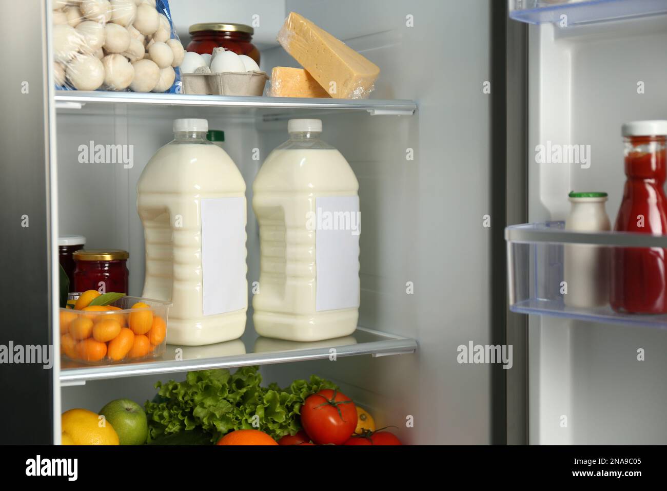 https://c8.alamy.com/comp/2NA9C05/gallons-of-milk-and-different-products-in-refrigerator-closeup-2NA9C05.jpg