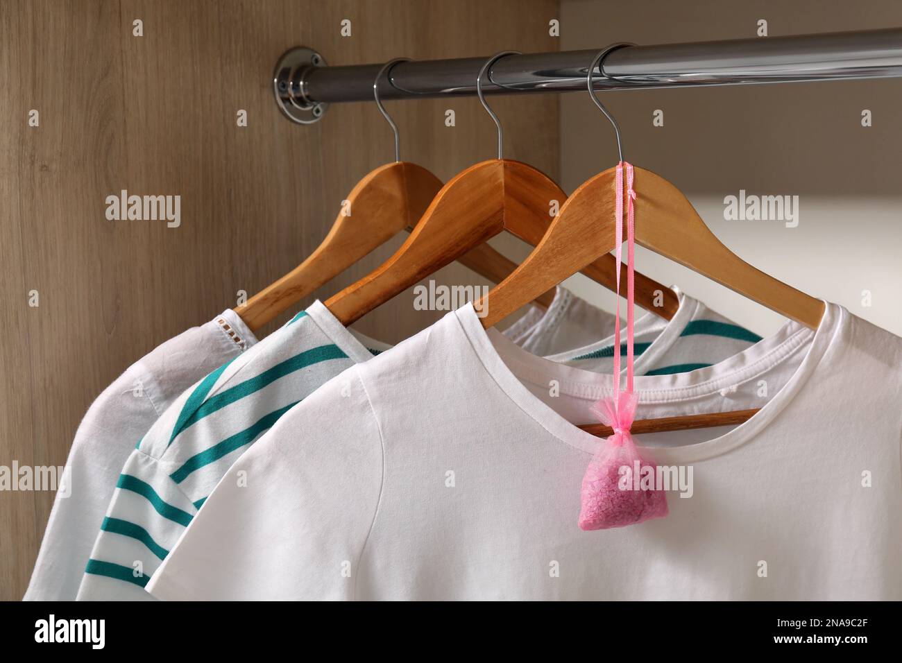Scented sachet and clothes hanging in wardrobe Stock Photo Alamy