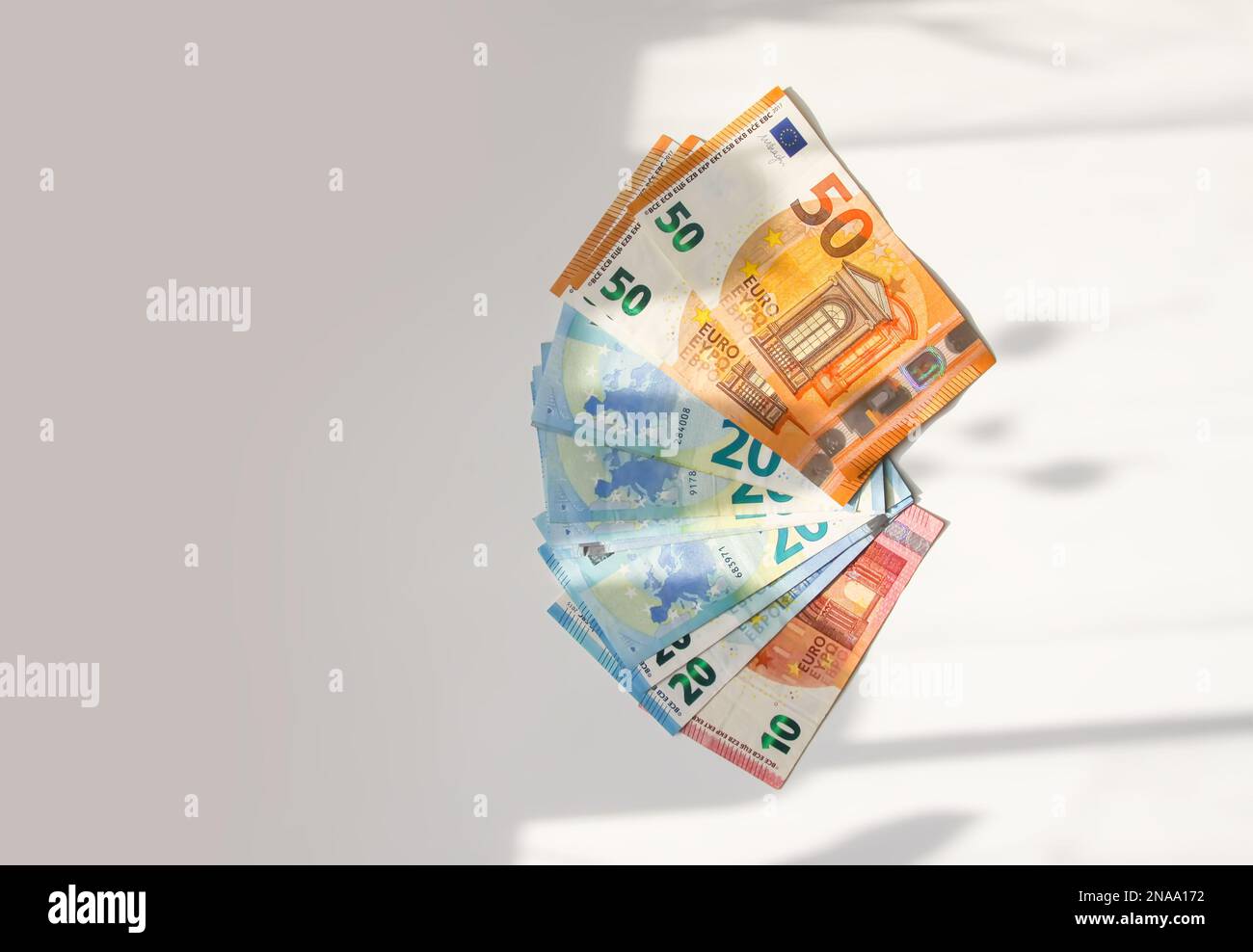 Euro money banknotes on a light background close up Stock Photo - Alamy