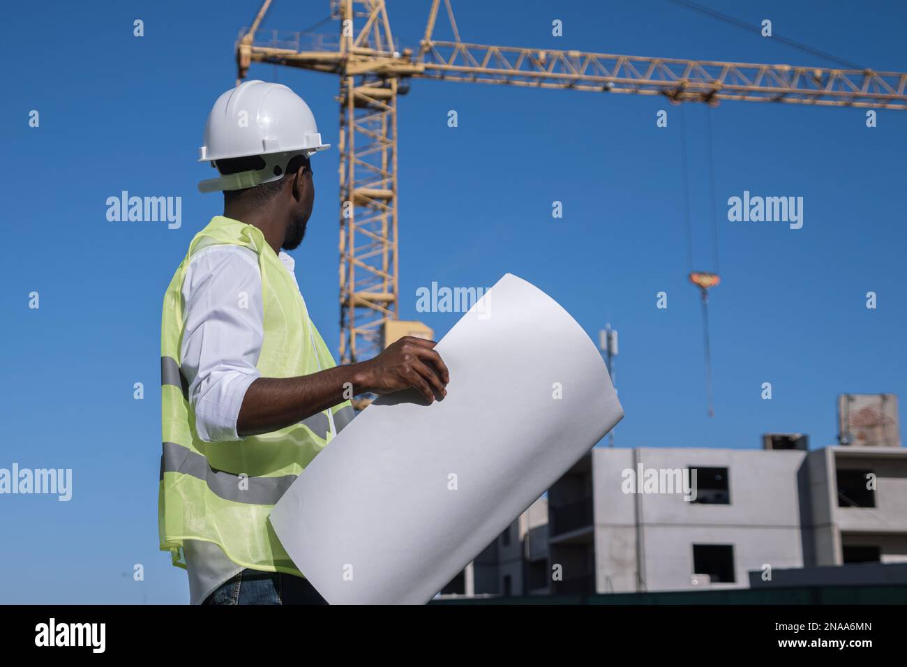 African American architect compares building to drawings Stock Photo