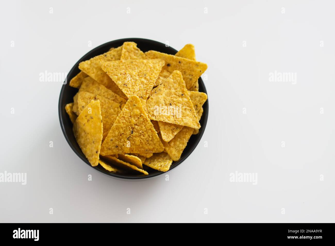 Tortilla chips in a black ceramic plate Stock Photo Alamy