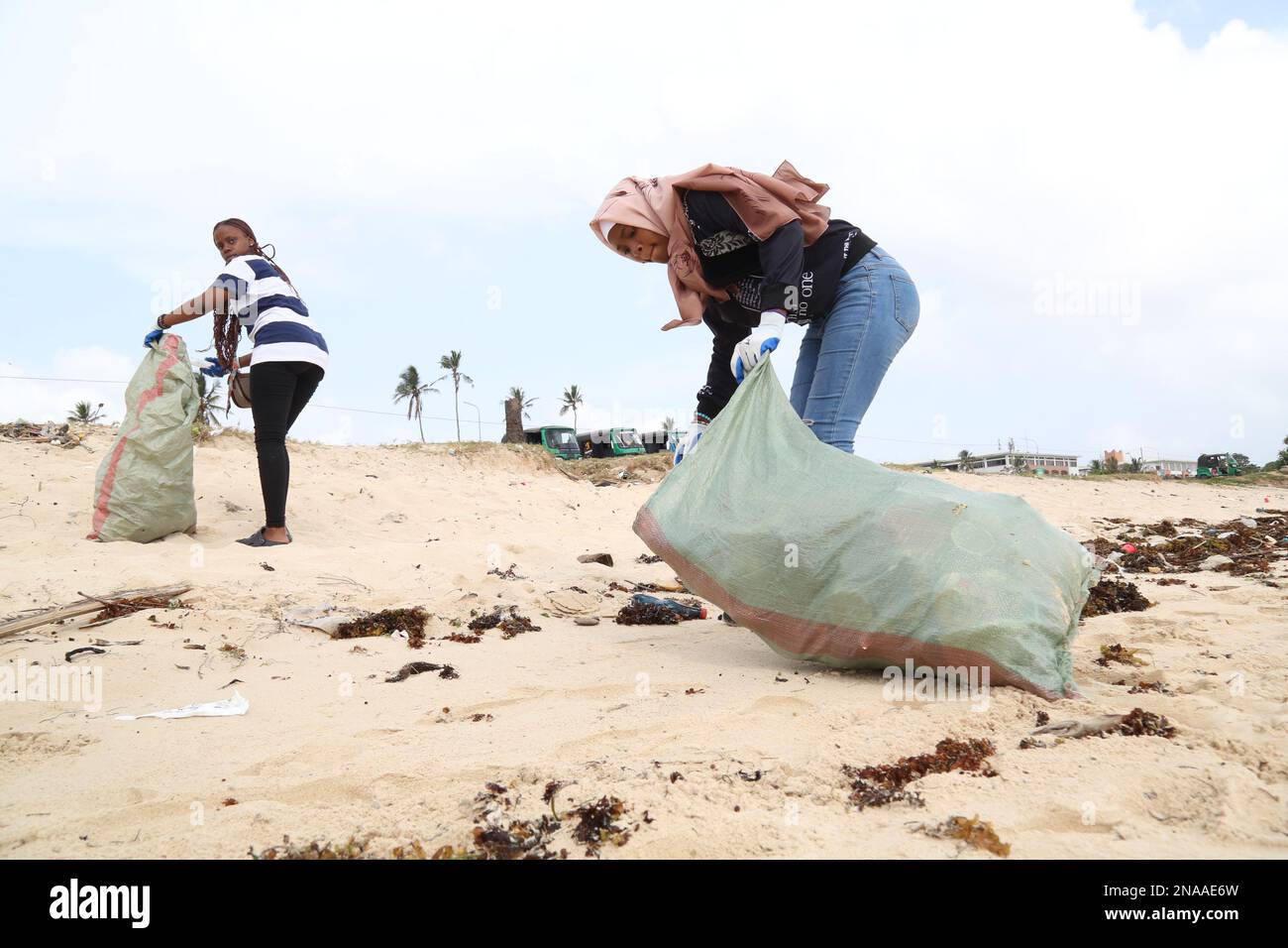 Dar Es Salaam, Tanzania. 7th Feb, 2023. People clean up waste on a beach in Dar es Salaam, Tanzania, Feb. 7, 2023. TO GO WITH 'Tanzania's waste collection campaign seeks to promote sustainable tourism' Credit: Herman Emmanuel/Xinhua/Alamy Live News Stock Photo