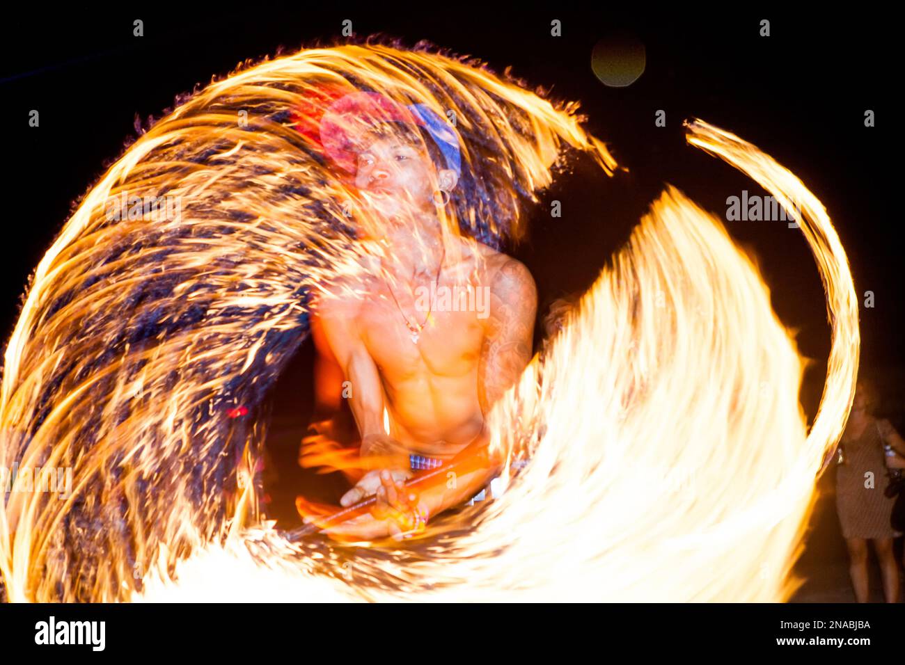A fire spinner on the beach in Thailand. Stock Photo