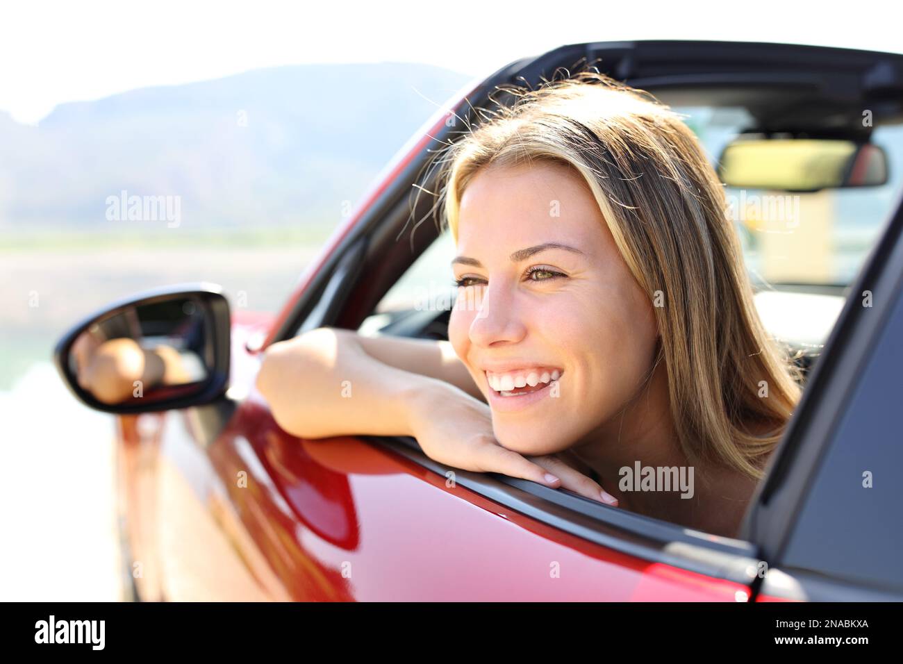 Happy car convertible driver laughing looking away Stock Photo
