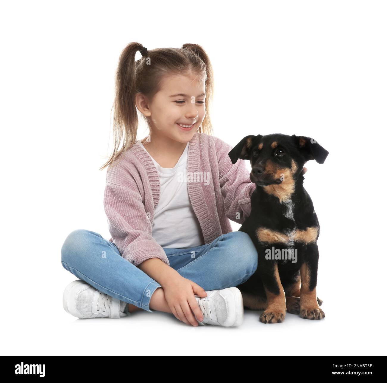 Little girl with cute puppy on white background Stock Photo