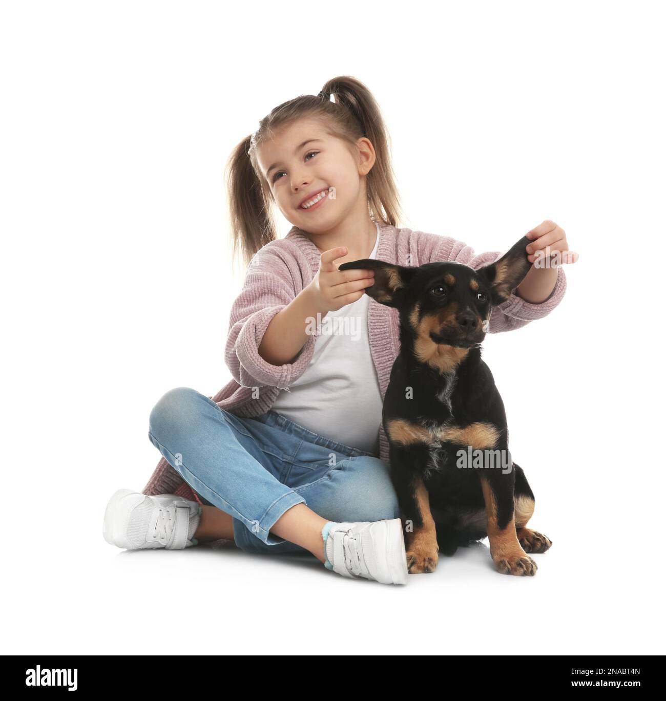 Little girl with cute puppy on white background Stock Photo