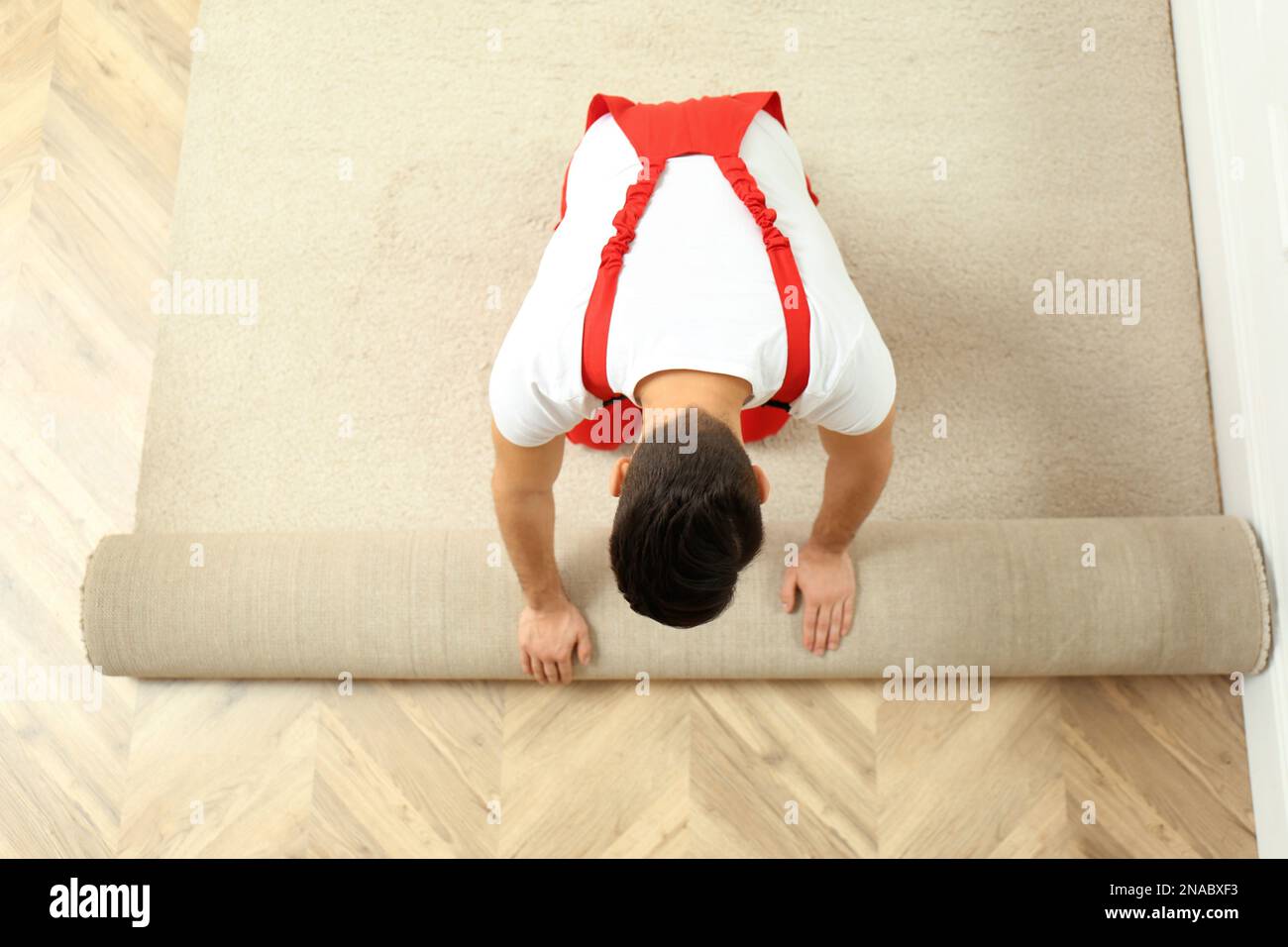 Worker with cutter knife and measuring tape installing new carpet indoors,  closeup Stock Photo - Alamy