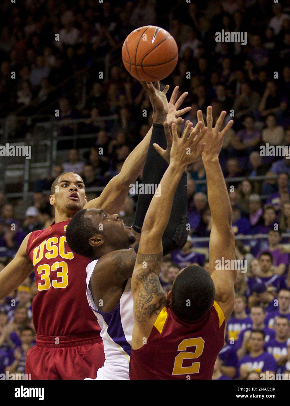 Washington's Tony Wroten, center, drives to the hoop against the USC's