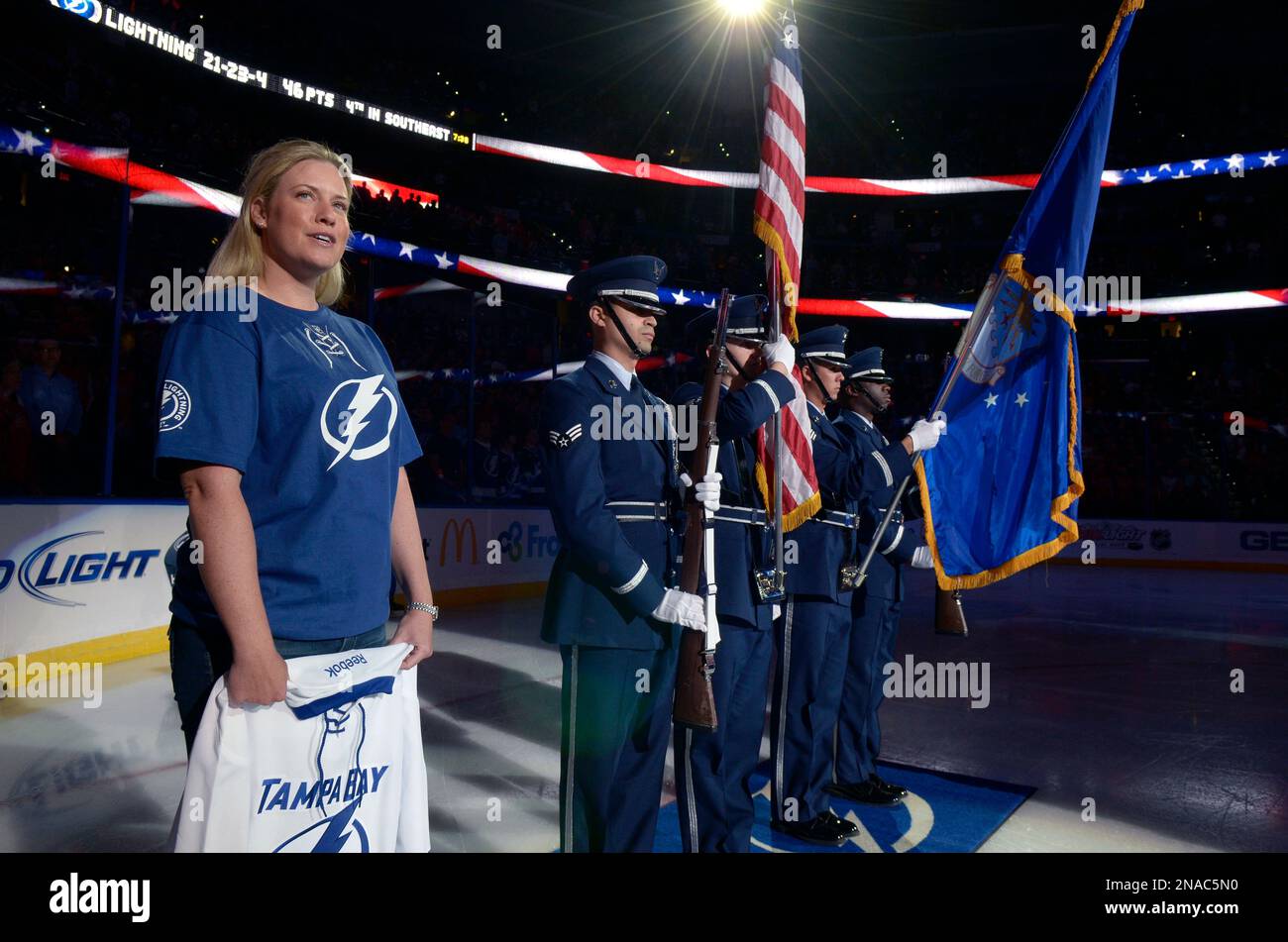 LPGA golfer Brittany left, stands on the ice for the singing