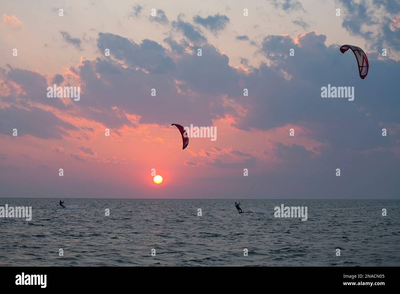 Kiteboarders on the Pamlico Sound at sunset, North Carolina, USA; Avon, North Carolina, United States of America Stock Photo