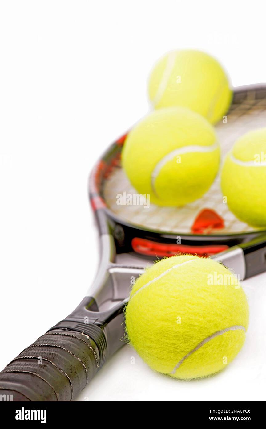Yellow tennis balls and tennis racket isolated on a white background ...