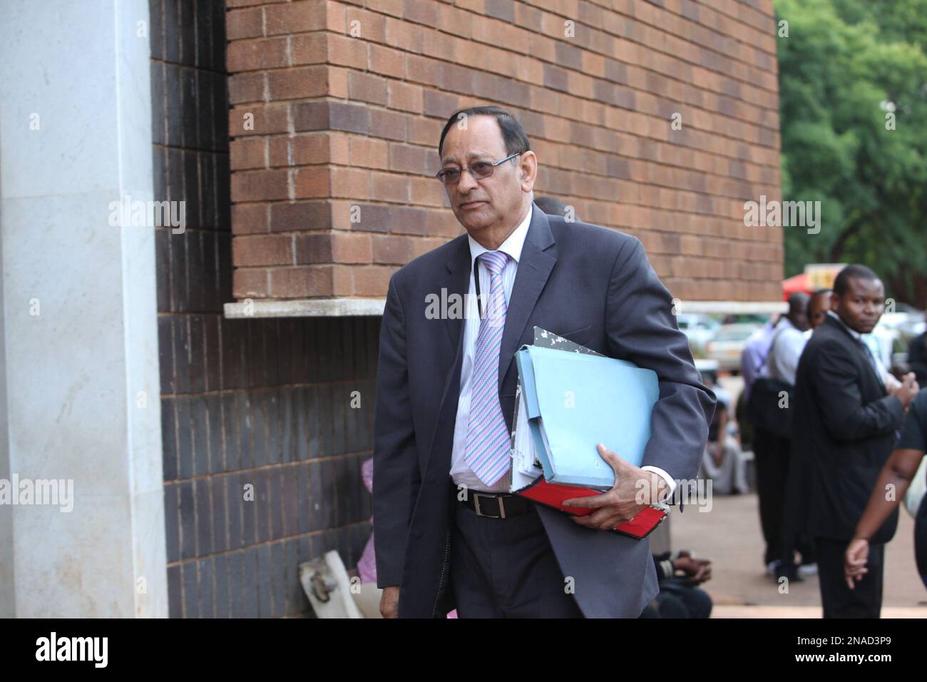 Thakor Kewada, a Mujuru family lawyer arrives at the Harare magistrates ...