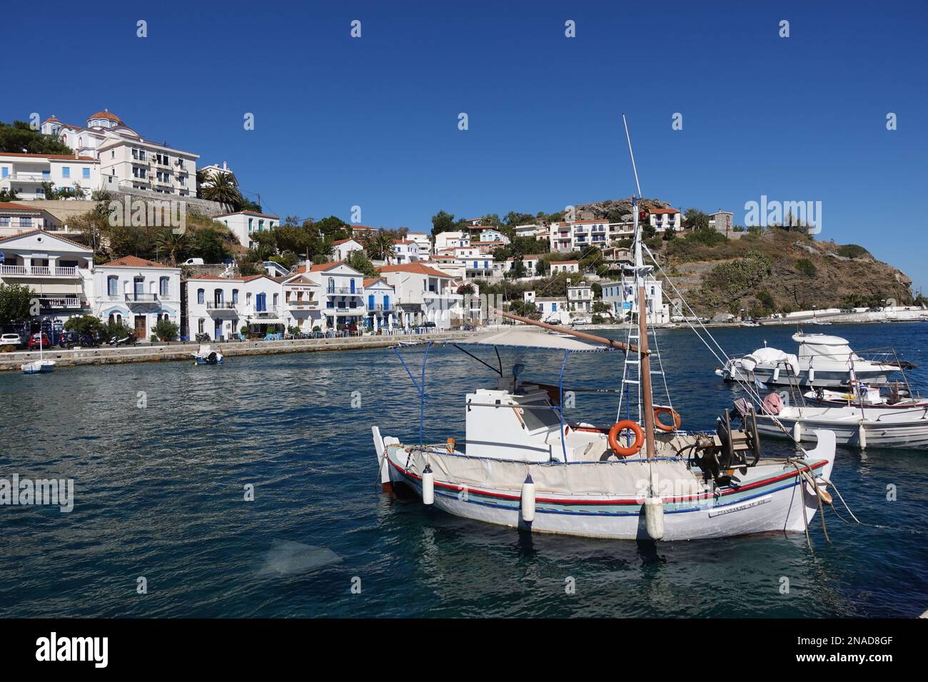 Small typical Greek fishing boat in the quaint harbour in Evdilos, Ikaria, Greece Stock Photo
