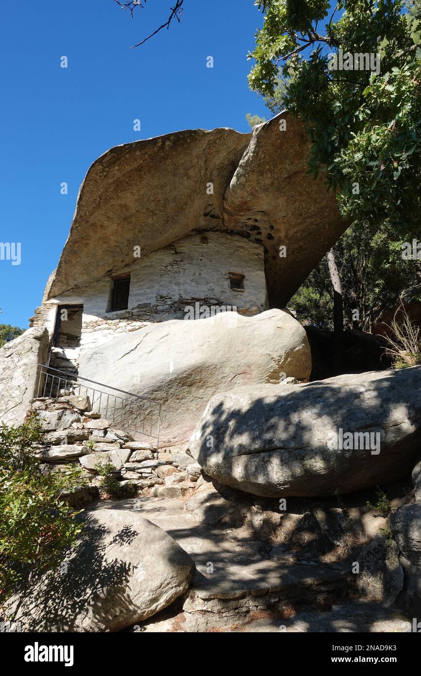 Chapel of Theoskepasti a small chapel in a cave covered by a rock located behind Theoktistis Monastery, Ikaria, Greece Stock Photo