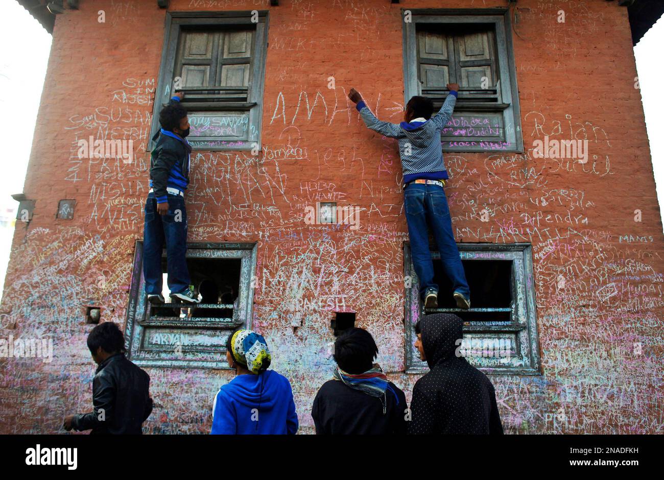 Nepalese Boys Write Their Names On The Wall Of The Saraswati Temple nepalese-boys-write-their-names-on-the-wall-of-the-saraswati-temple
