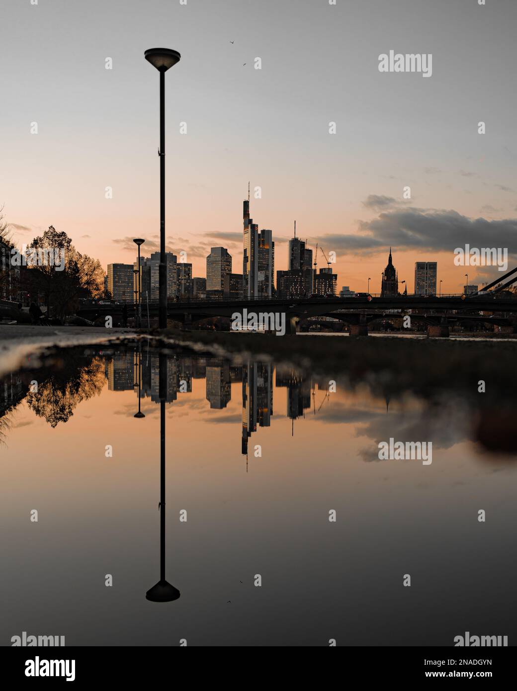 The cityscape with modern buildings reflected in water at sunset Stock ...