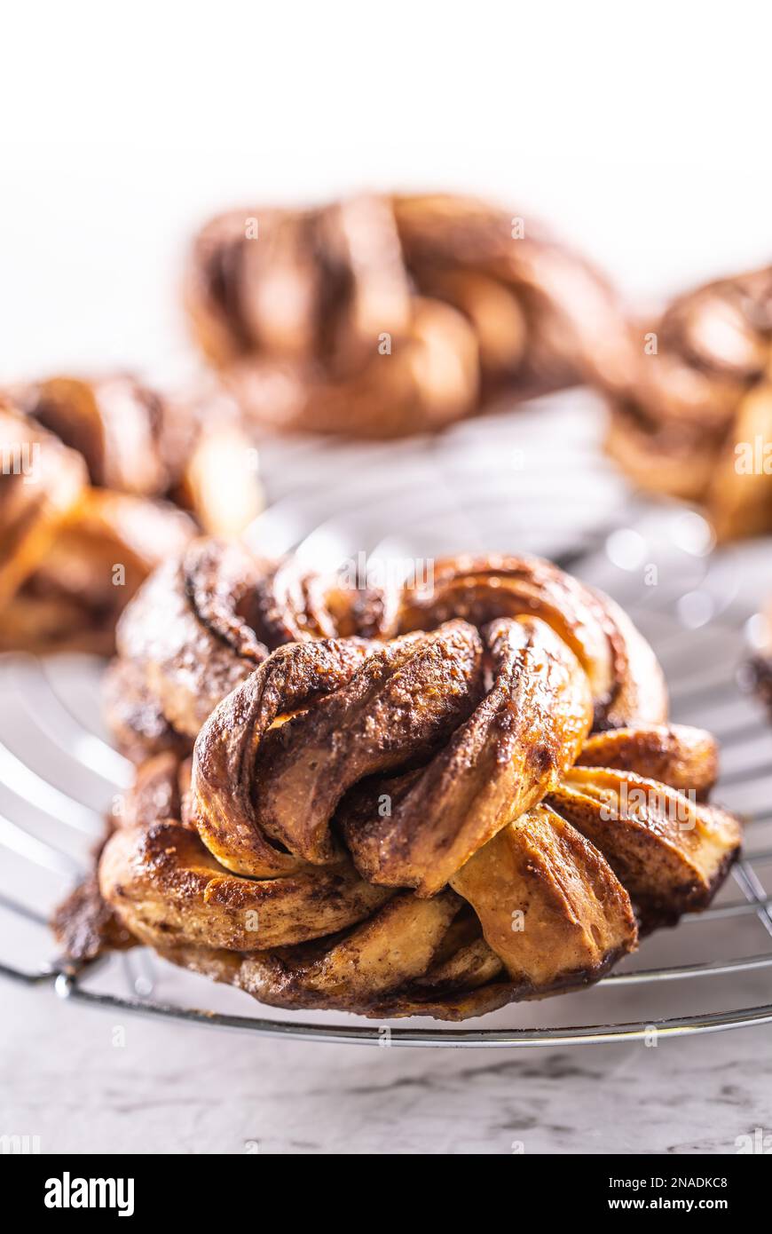 Freshly baked, caramel-cinnamon buns on the kitchen grill. Stock Photo