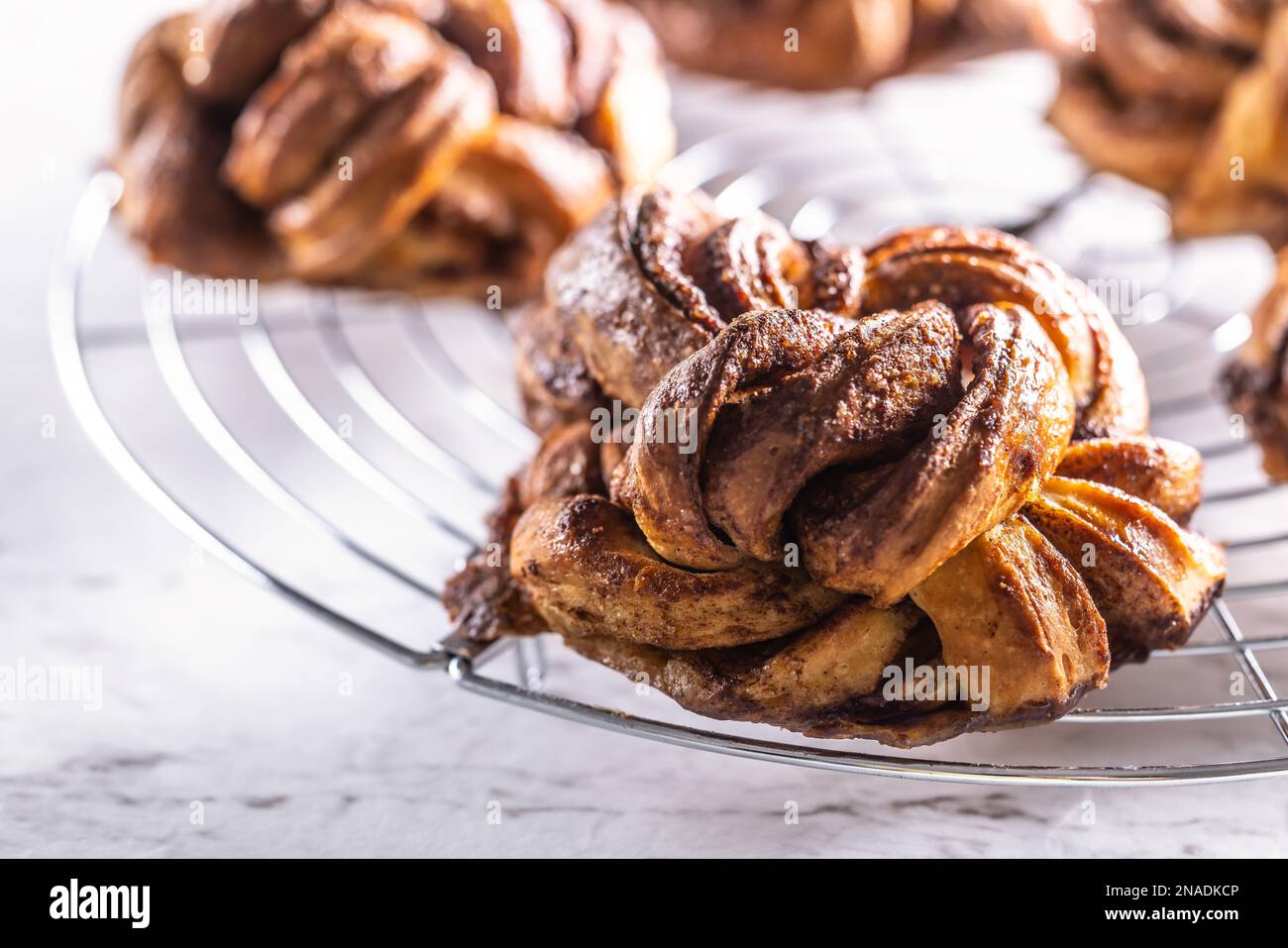 Freshly baked, caramel-cinnamon buns on the kitchen grill. Stock Photo