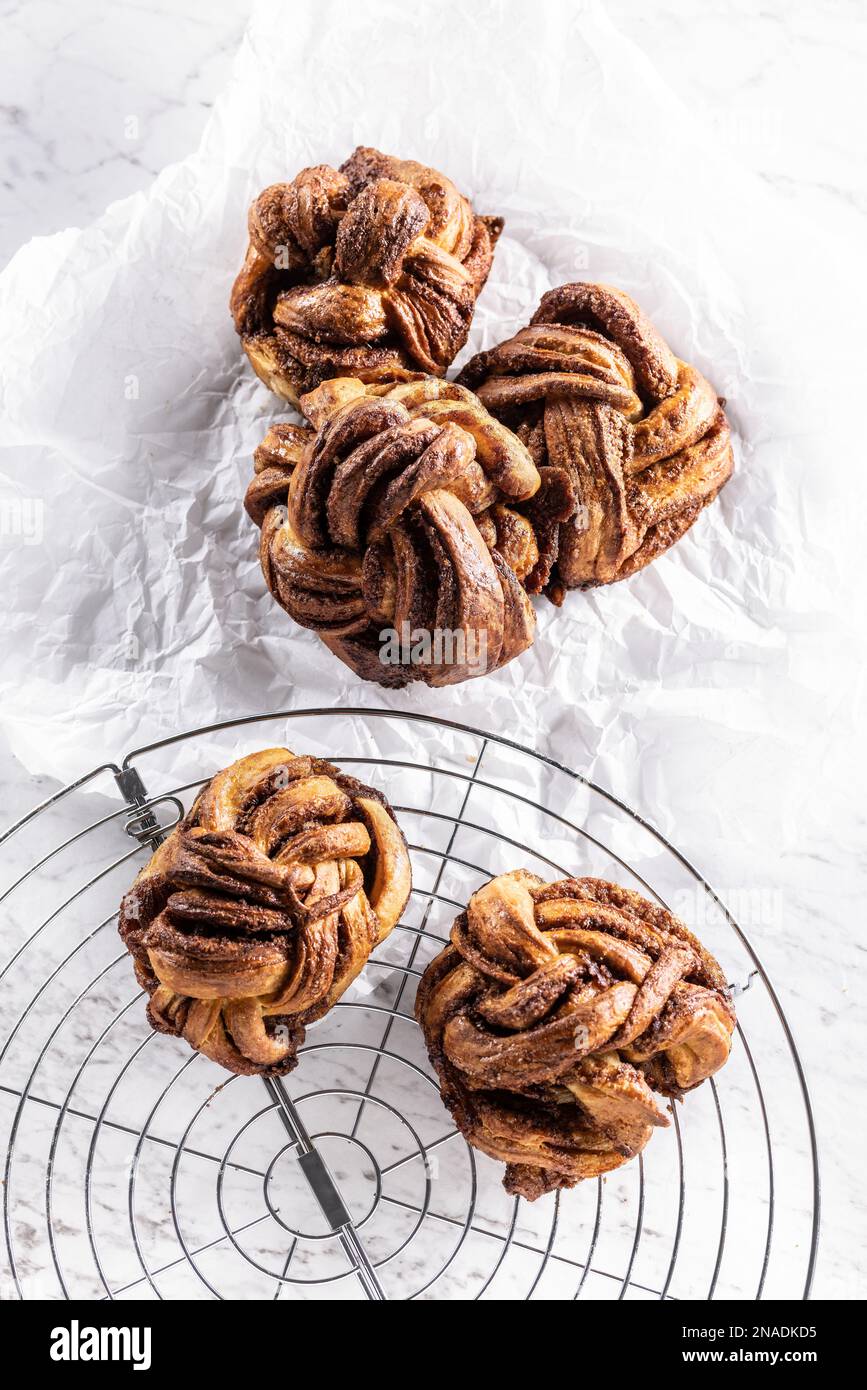 Freshly baked, caramel-cinnamon buns on the kitchen grill - Top of view. Stock Photo