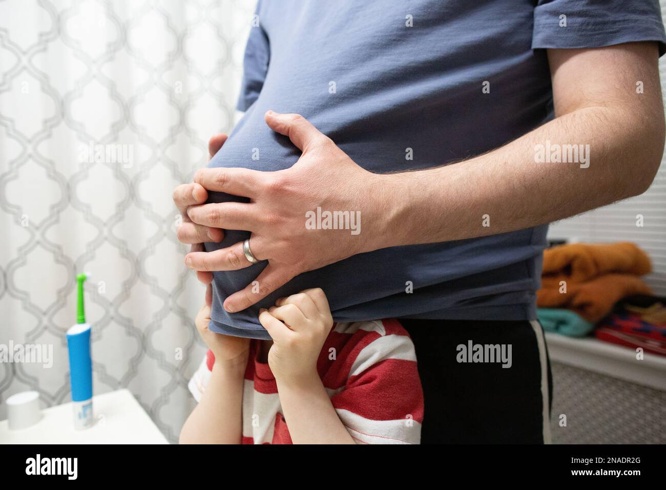 Playful Dad with Preschool Age Son Standing in Bathroom Stock Photo