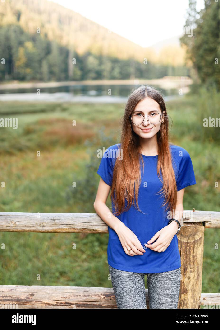 female tourist near a mountain forest lake Stock Photo