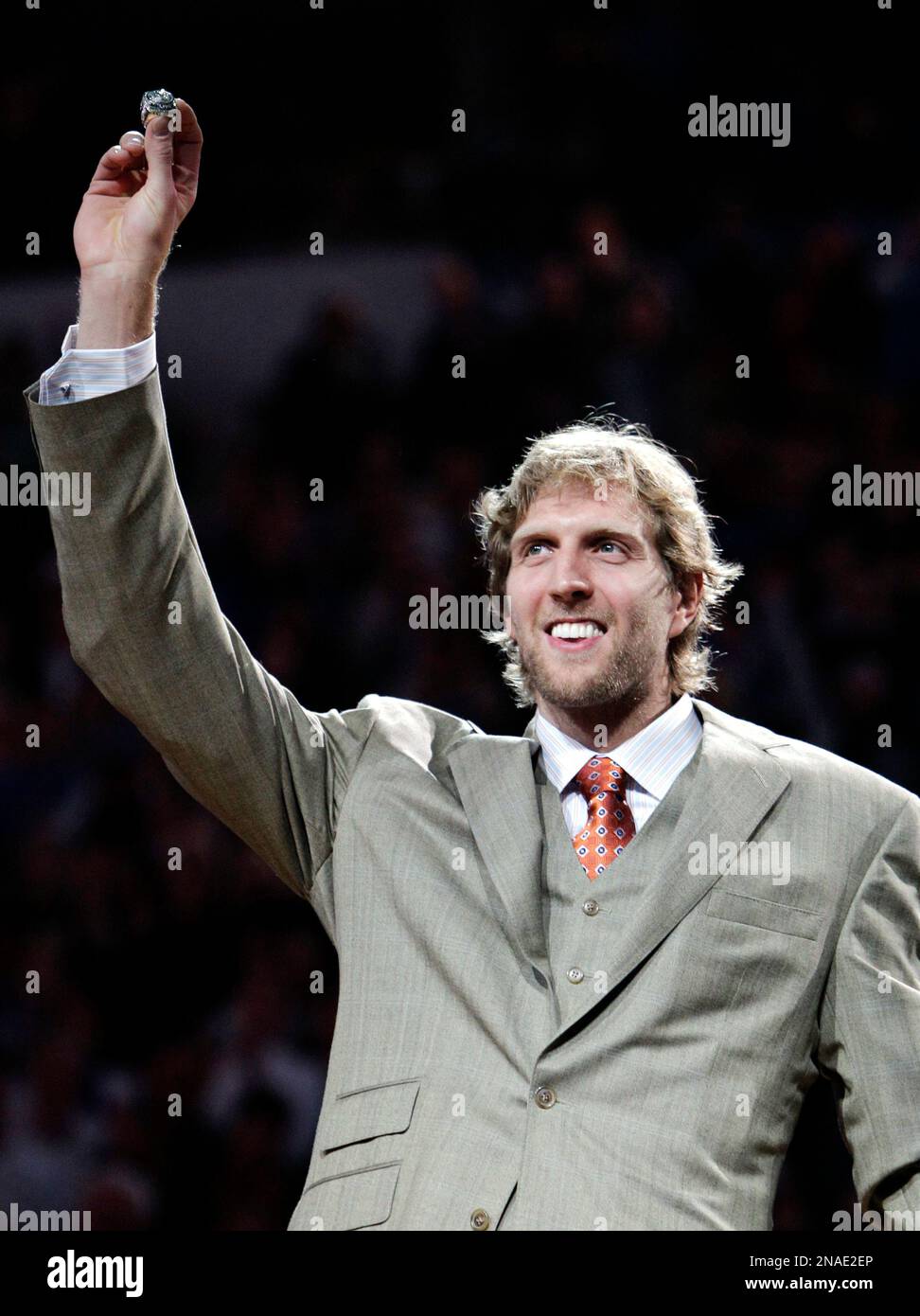 Dirk Nowitzki of the Mavericks holds the championship trophy after  defeating the Heat during Game 6 of the NBA Finals at the AmericanAirlines  Arena in Miami, Florida, Sunday, June 12, 2011. The