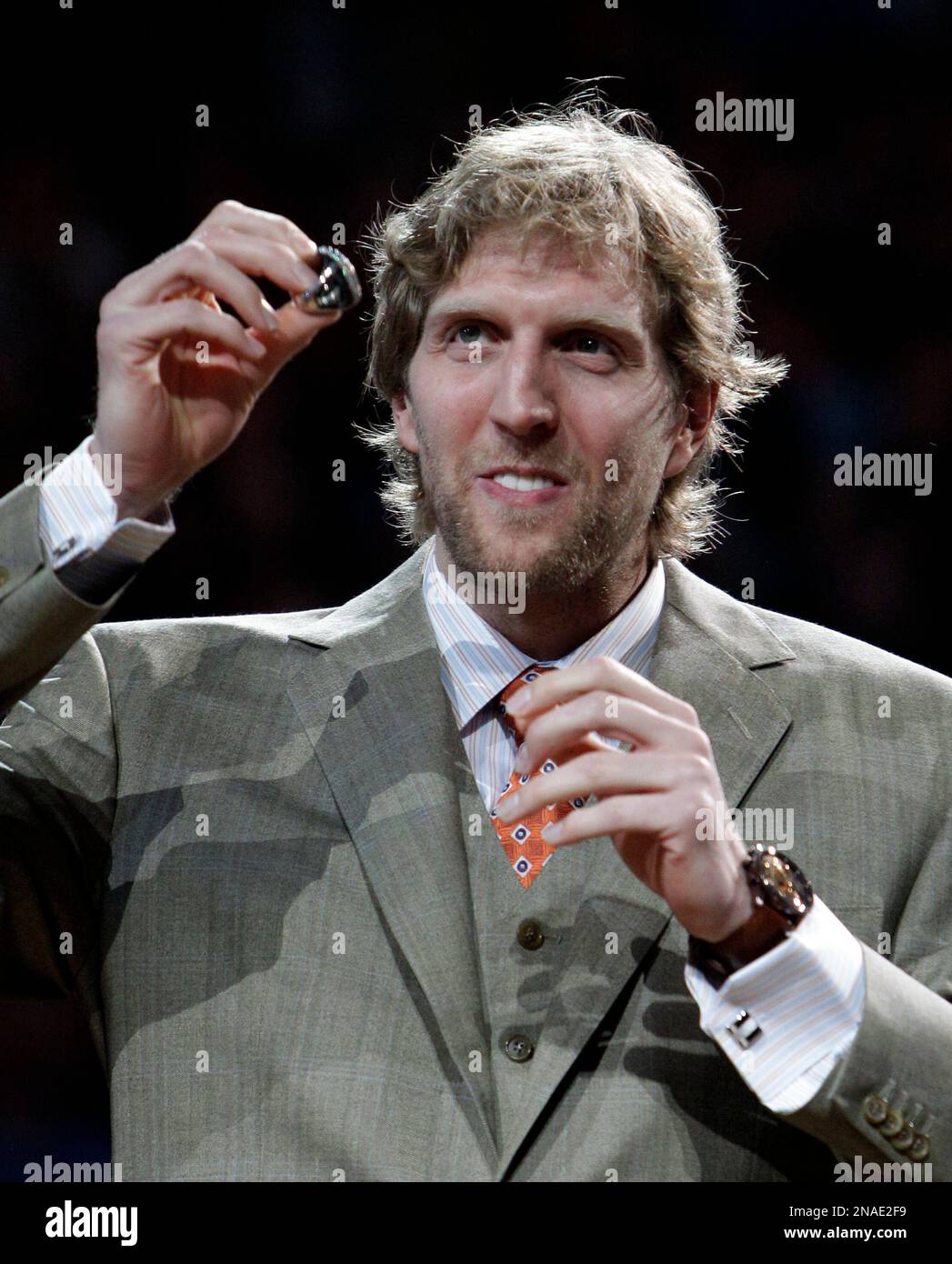 Dirk Nowitzki of the Mavericks holds the championship trophy after  defeating the Heat during Game 6 of the NBA Finals at the AmericanAirlines  Arena in Miami, Florida, Sunday, June 12, 2011. The