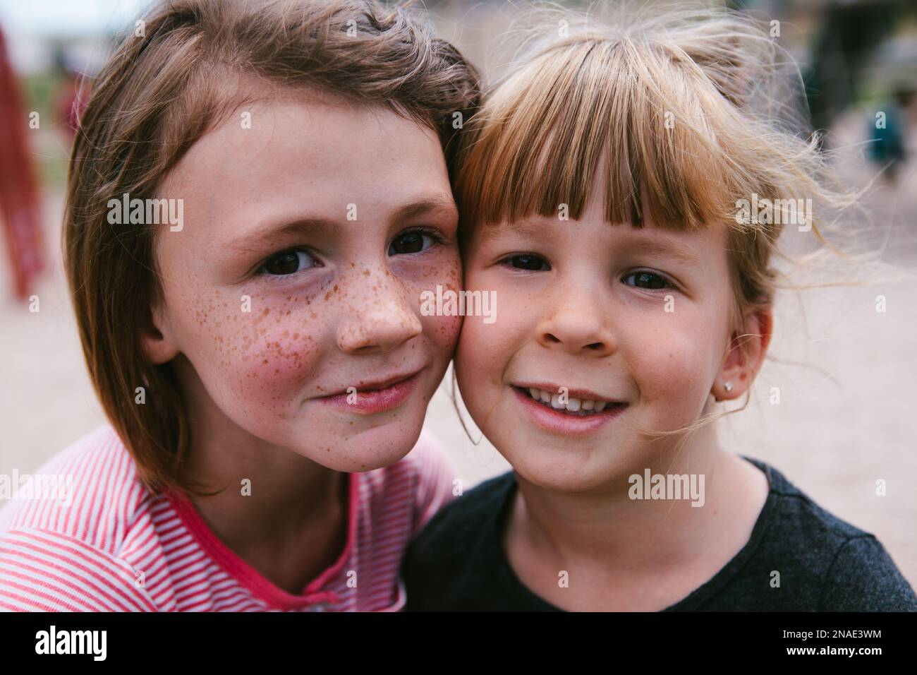 Kids with freckles together outside faces close and happy Stock Photo