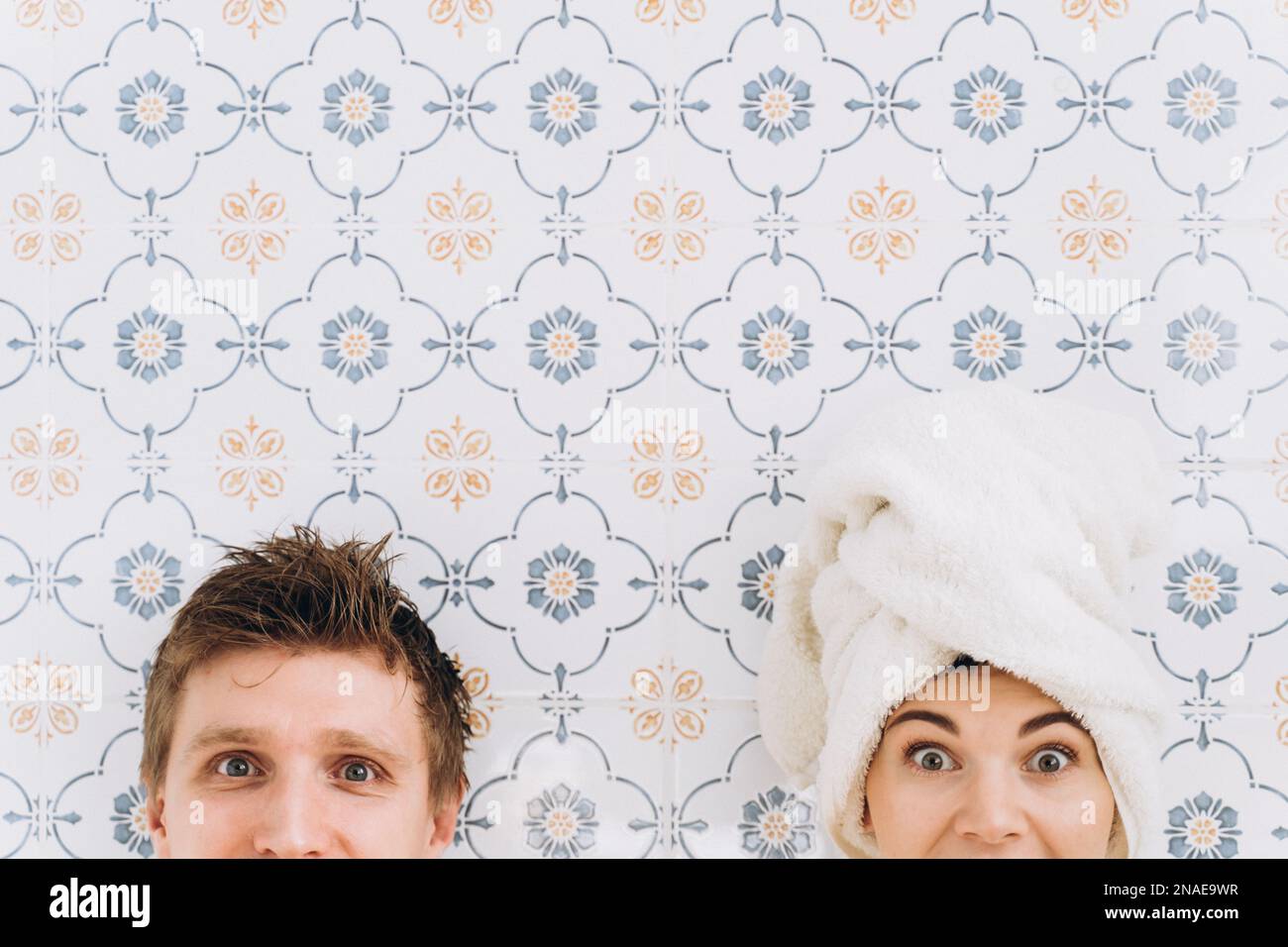 A guy and a girl with a towel on their heads, surprised faces Stock