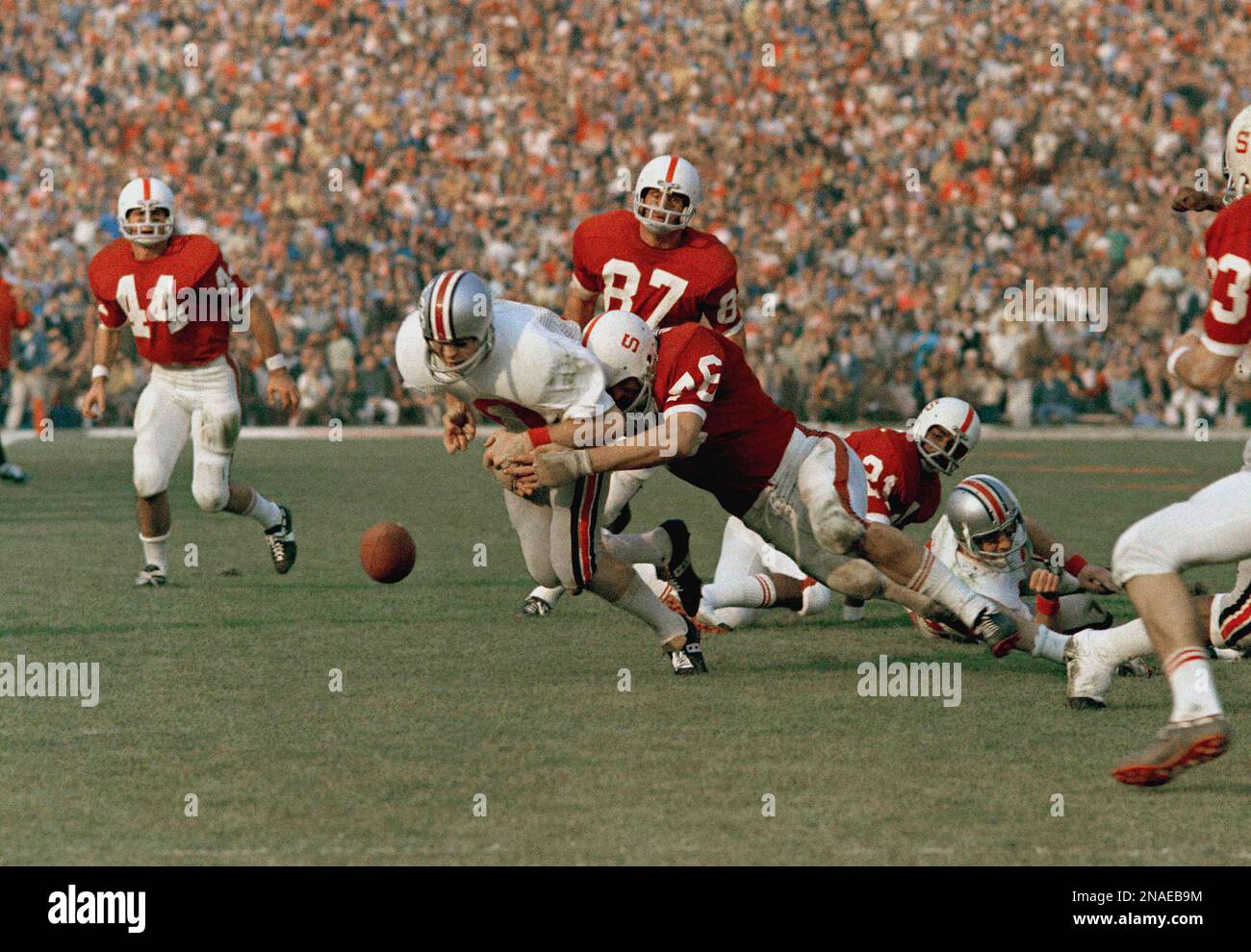 Quarterback Rex Kern of Ohio State fumbles as he is hit by tackle Dave