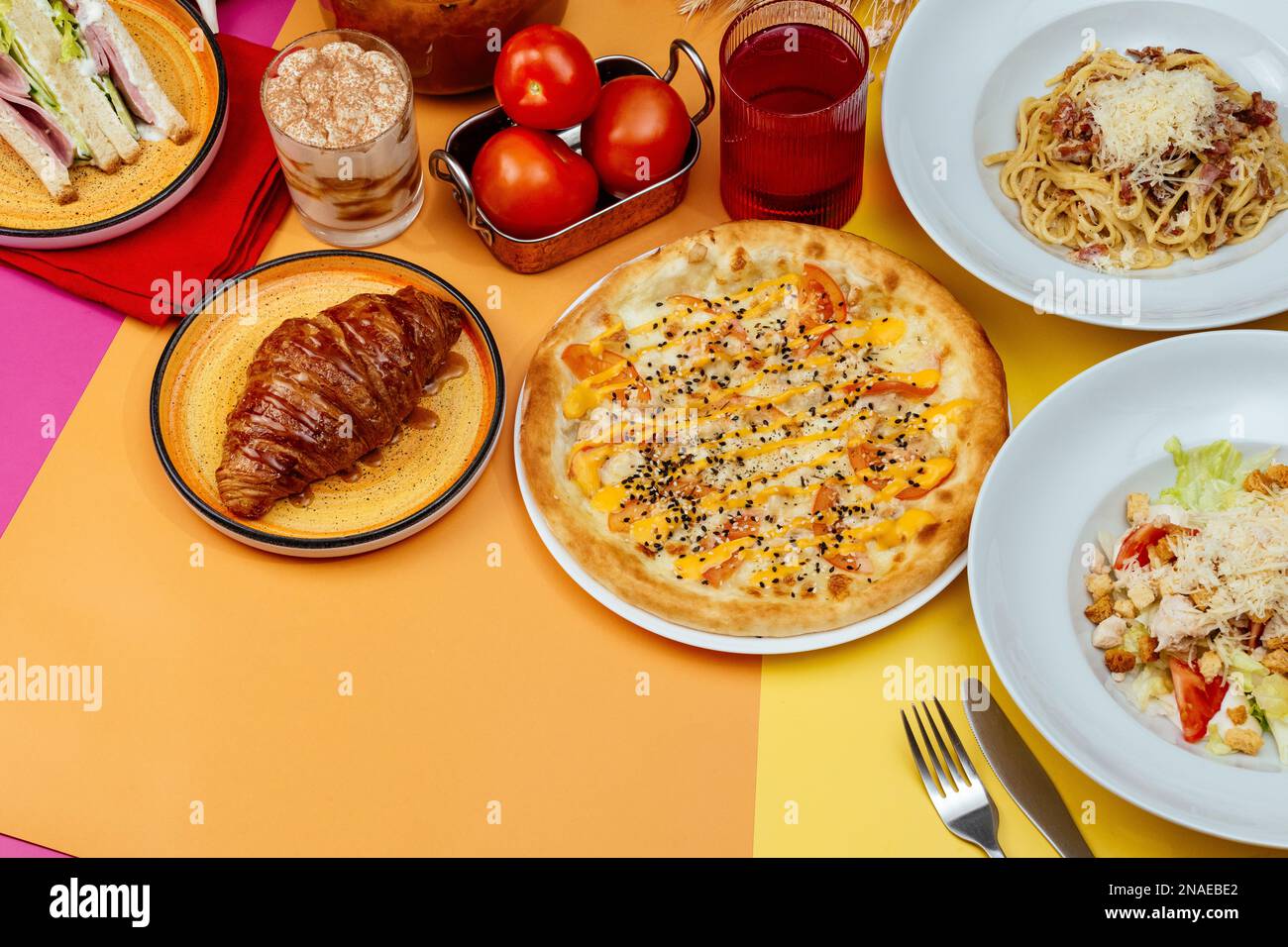 Italian pasta, pizza and caesar salad on bright backgrounds. moc Stock