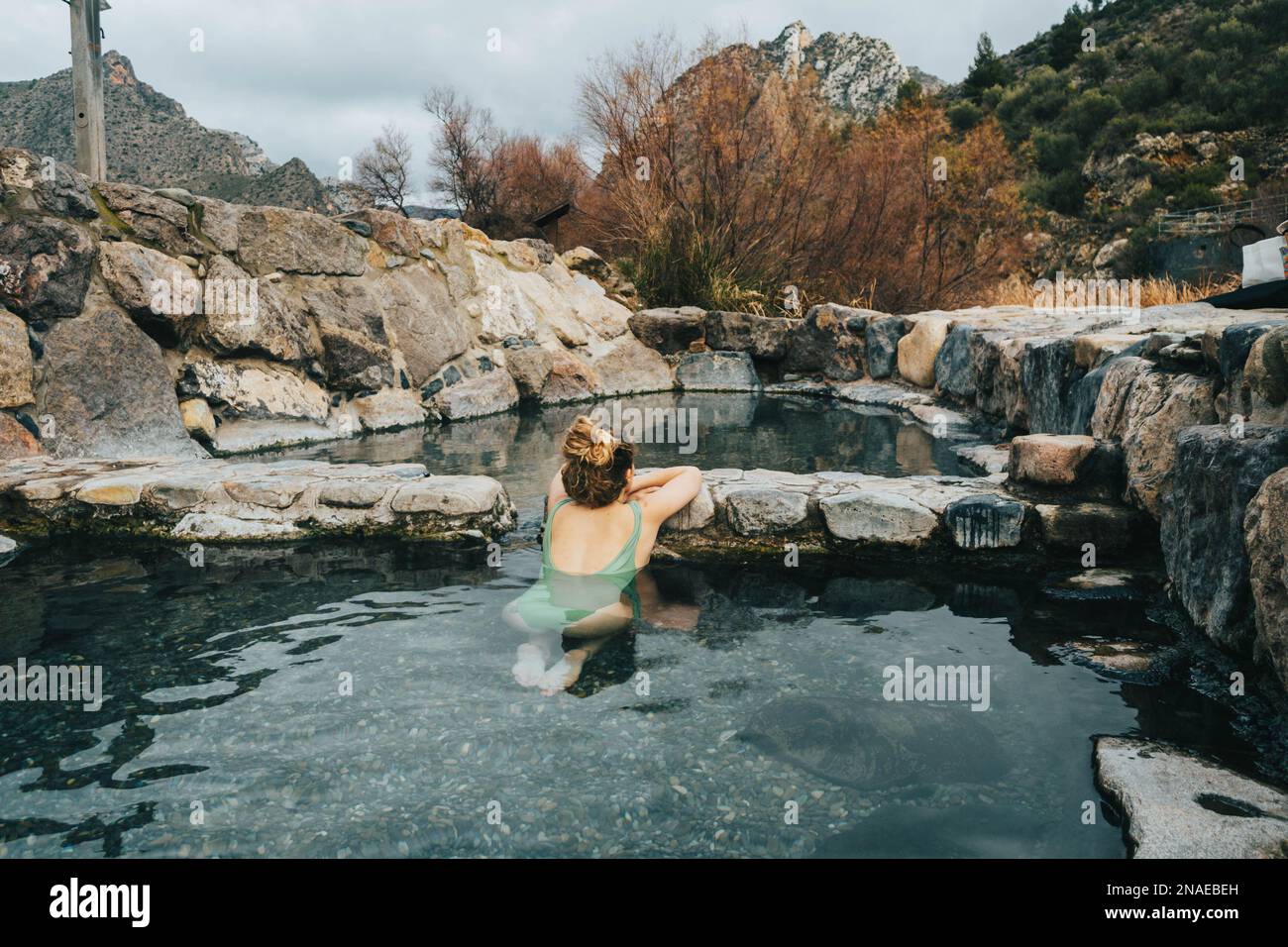 Portrait of woman in natural hot springs relaxing Stock Photo