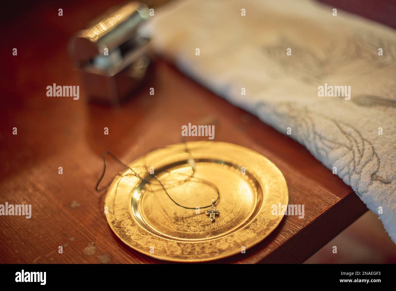 dish with , pectoral cross for christening on altar. Orthodox baptism of baby. Catholic infant