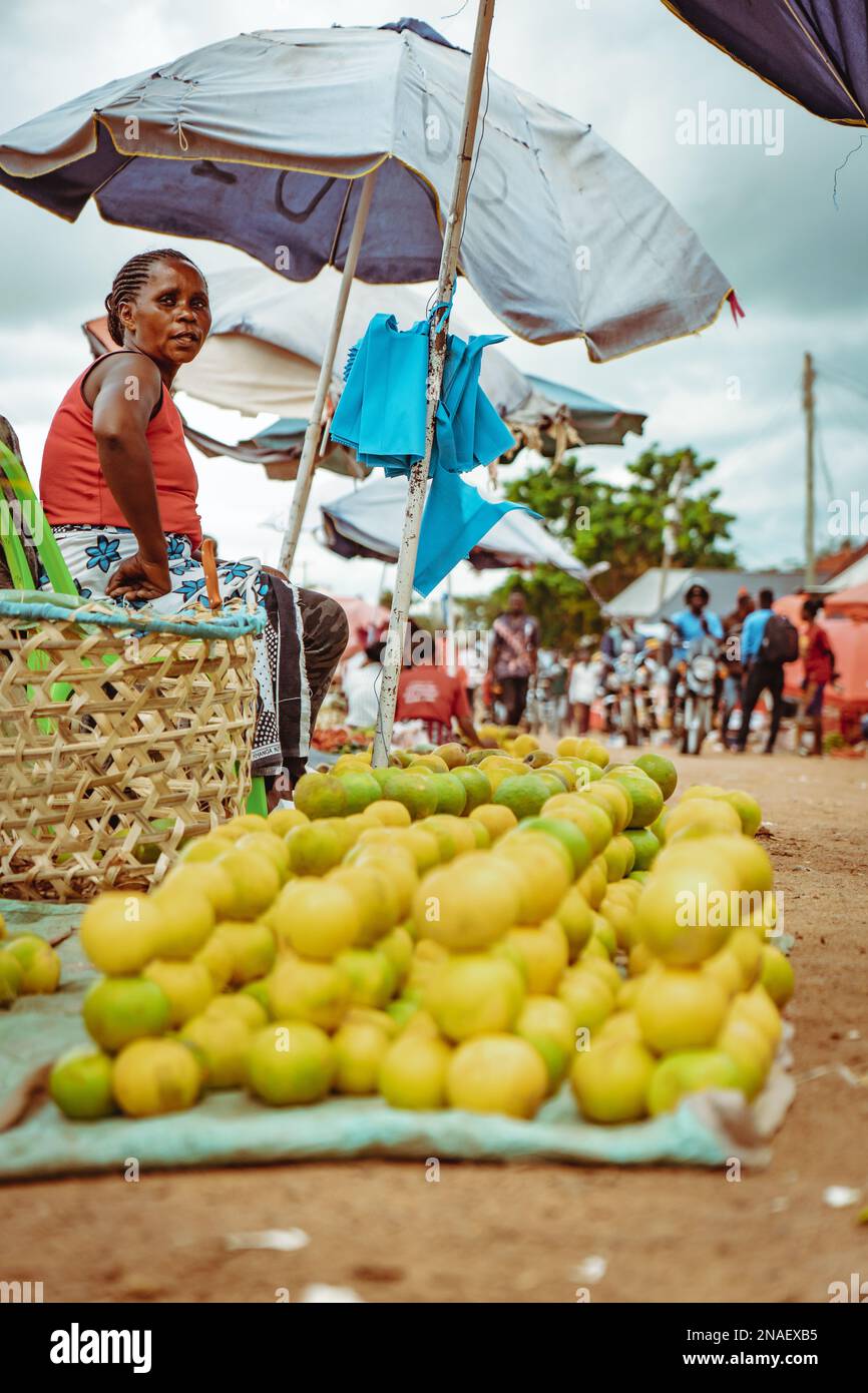 02.05.2022 - Mwanza, Tanzania - Woman selling African oranges in a small market in rural village Stock Photo