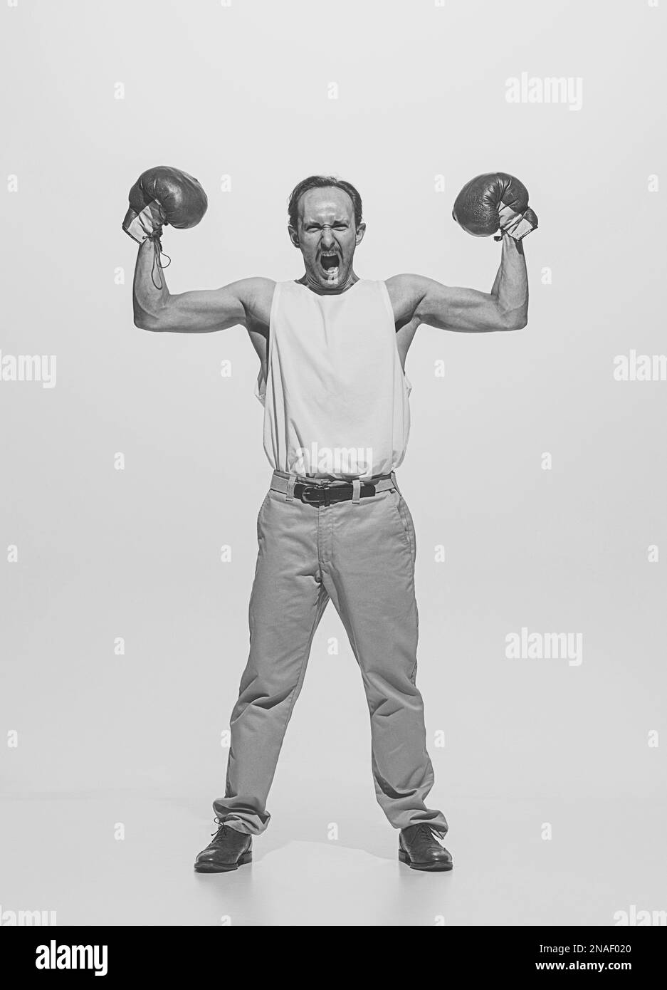 Portrait of muscular retro man in vintage clothes showing muscles