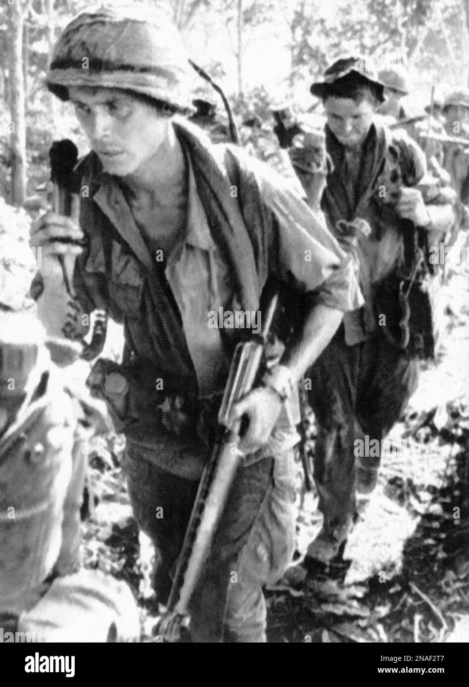 U.S. First Cavalry Division radioman keeps close attention to a