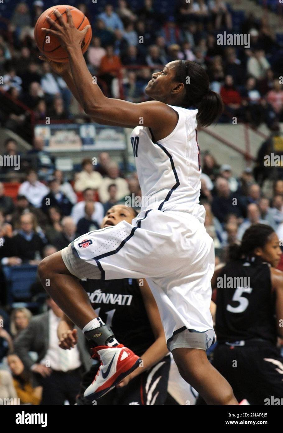 Connecticut's Tiffany Hayes comes in for a shot past Cincinnati's