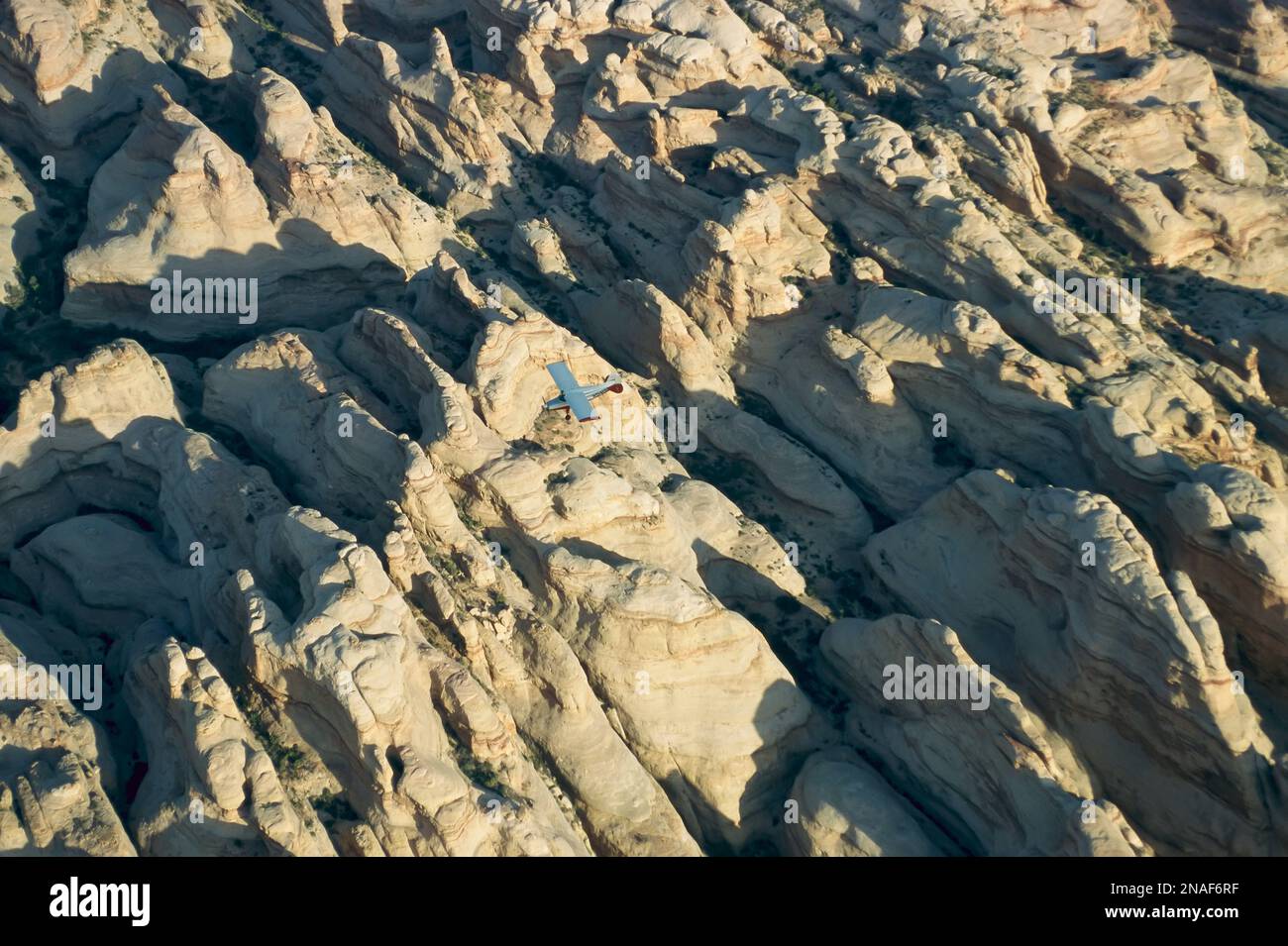 A small aircraft flies above Canyonlands National Park; Utah, United