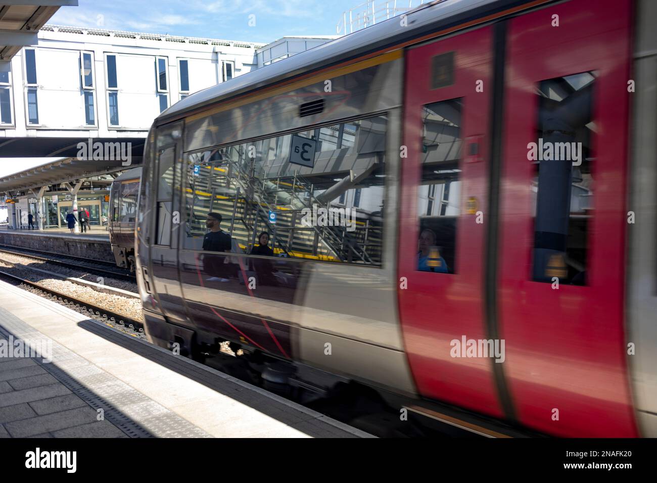 Passenger train on the tracks in a station; Coventry, England Stock