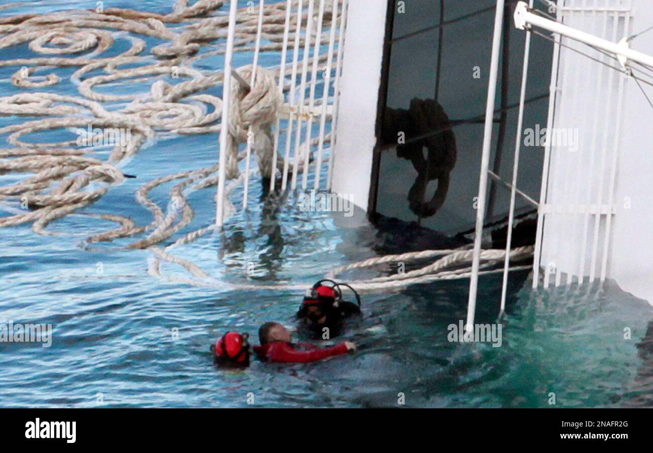 A scuba diver recovers a body from the cruise ship Costa Concordia
